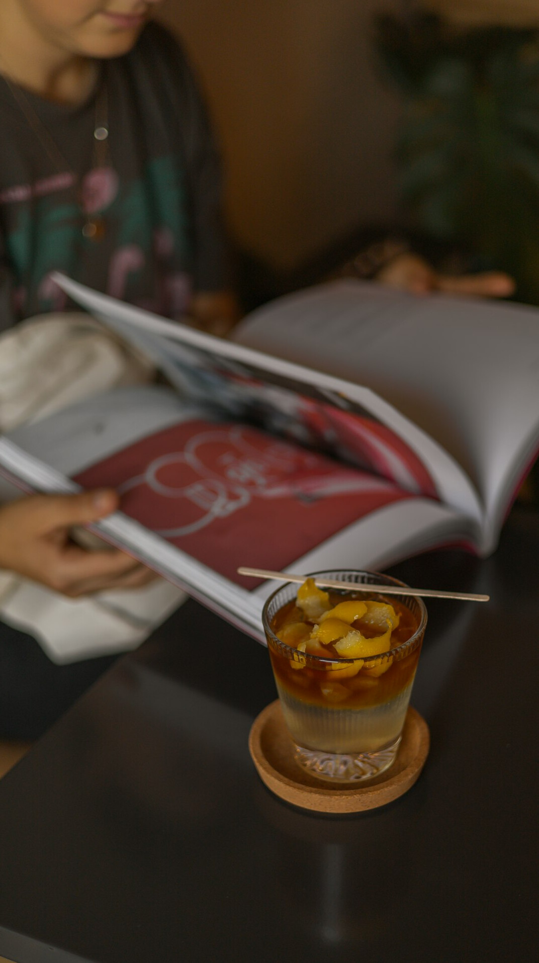 Editorial team meeting around a table with magazines and laptops